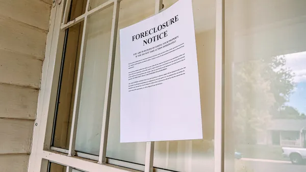 Paper Foreclosure Notice Taped to the Front Door of a Home
