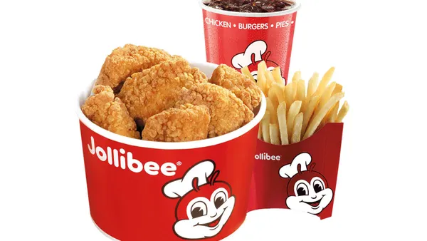 A bunch of chicken nuggets, a drink and a side.