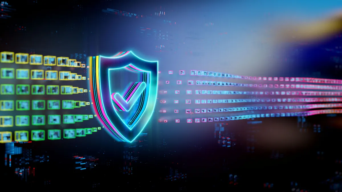 Multi-color shield with a check mark in the middle of it, in front of abstract tech background.