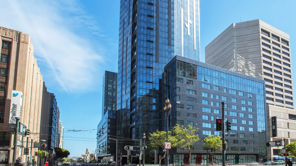 the bottom of a high-rise building in San Francisco surrounded by streets smaller buildings