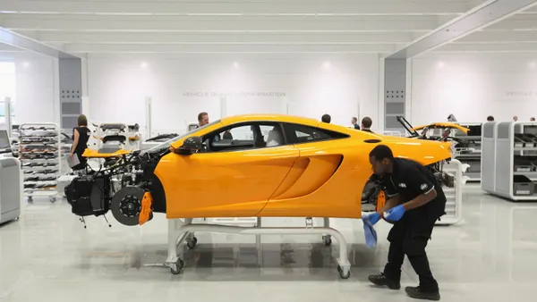 Workers assemble high performance McLaren MP4-12C sports cars in the Production Centre of the McLaren Technology Centre on November 17, 2011, in Woking, England.