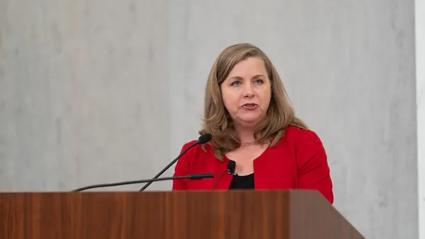 Federal Reserve Governor Michelle Bowman stands behind a podium and speaks.