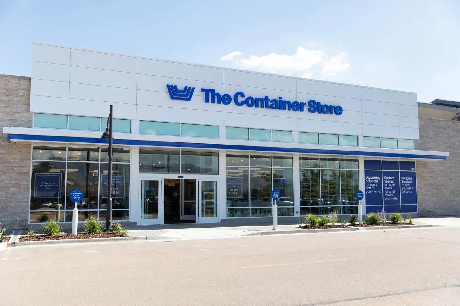 A white storefront with a blue Container Store logo on it.