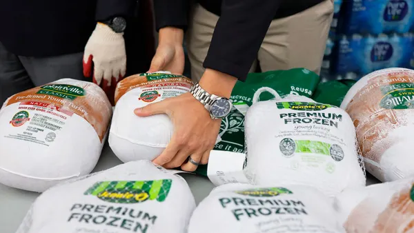 A person grabs a frozen Jennie-O turkey