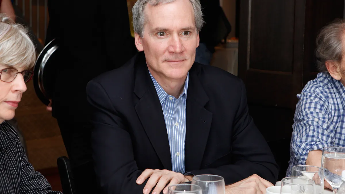 Stanford President Marc Tessier-Lavigne sits at a table.