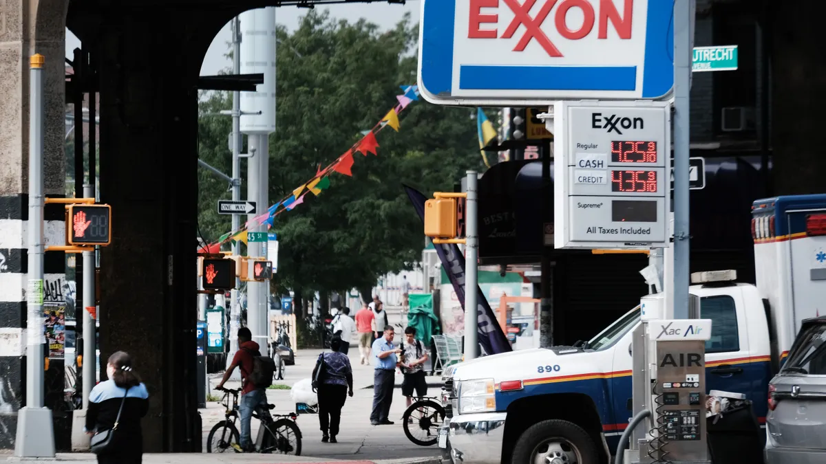 A photo of an exxon sign showing regular gas prices over $4 per gallon.