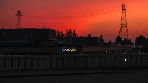 The Google logo is seen lit up at dusk in the Seattle skyline on July 4, 2023.