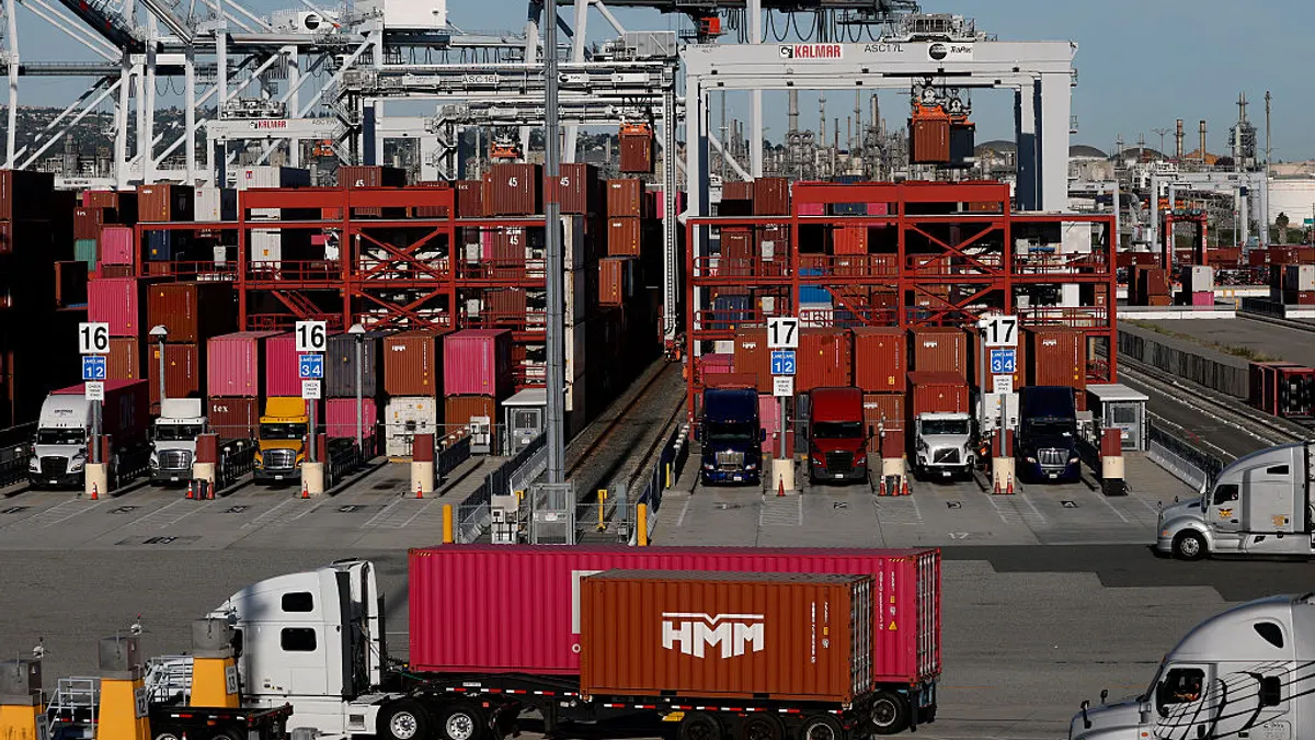 Several trucks moving at a TraPac terminal in Los Angeles.