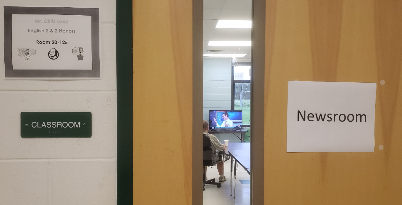 A man sits and watches the new in a school classroom that served as shelter during the storm