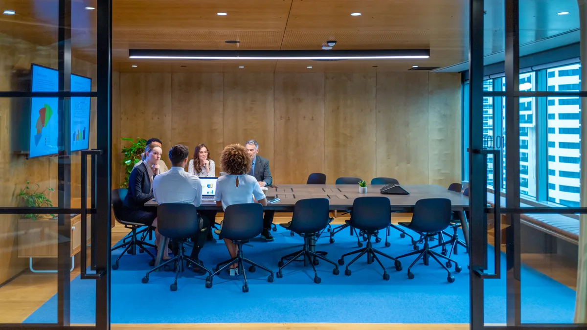 people meeting and working at a board room table