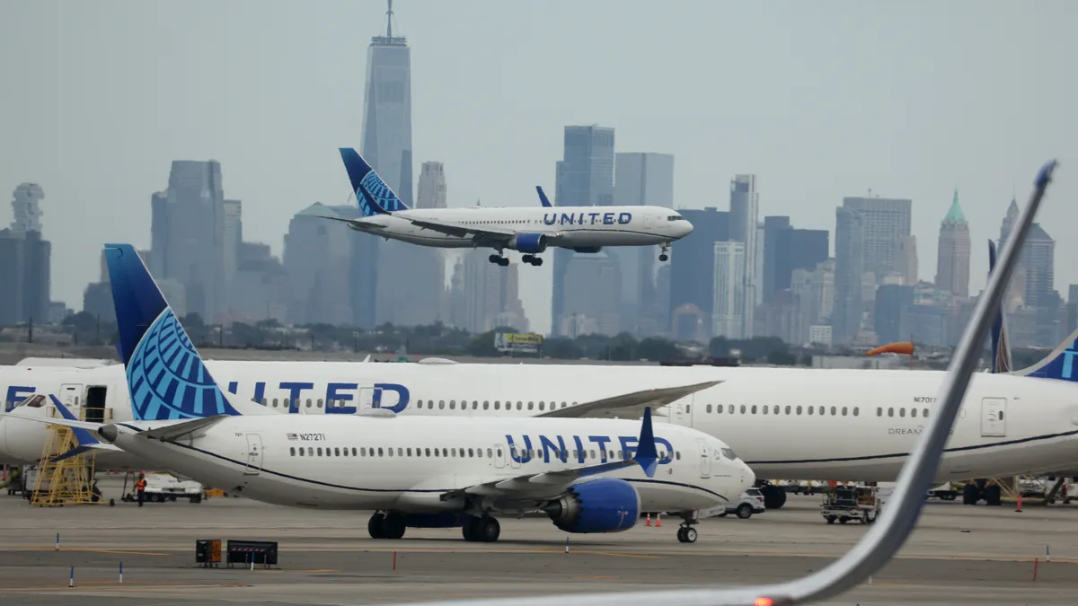 A United Airlines plane lands at Newark Liberty International Airport in front of the New York skyline on September 17, 2023 in Newark, New Jersey.