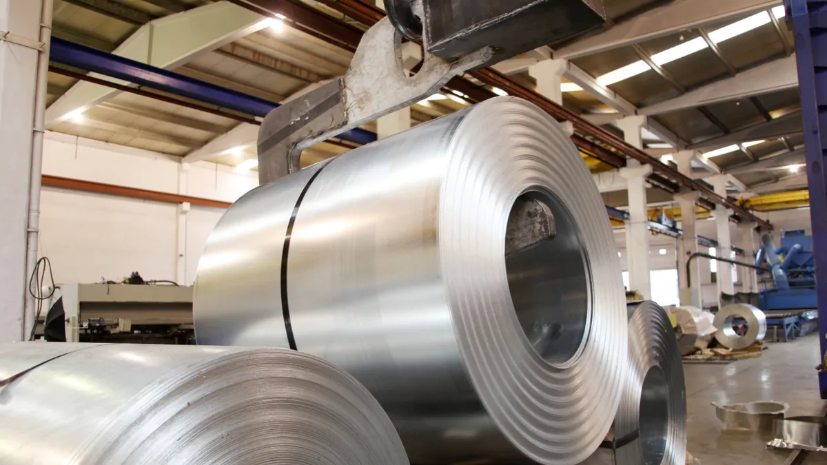 Large rolls of sheet aluminum stacked in a factory setting