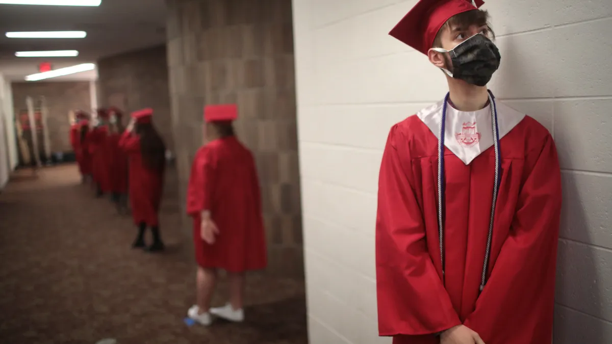 Students wait to walk across the stage to receive their diplomas during a graduation ceremony at Bradley-Bourbonnais Community High School in Bradley, Illinois.