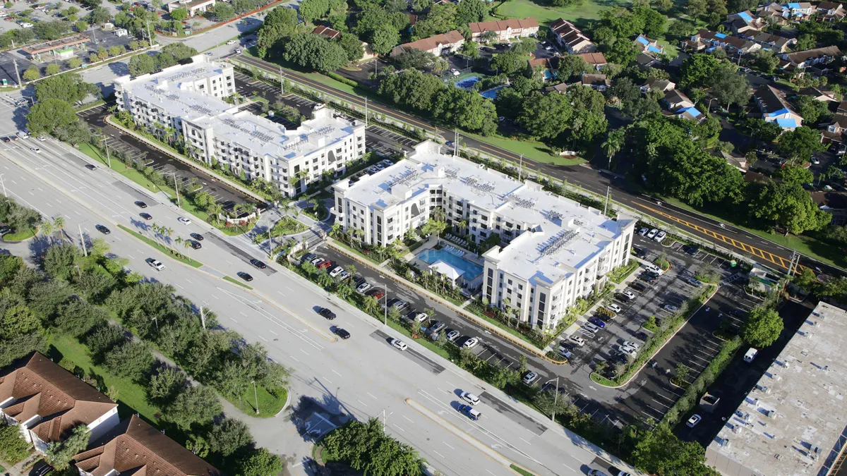 Aerial view of white apartment building.