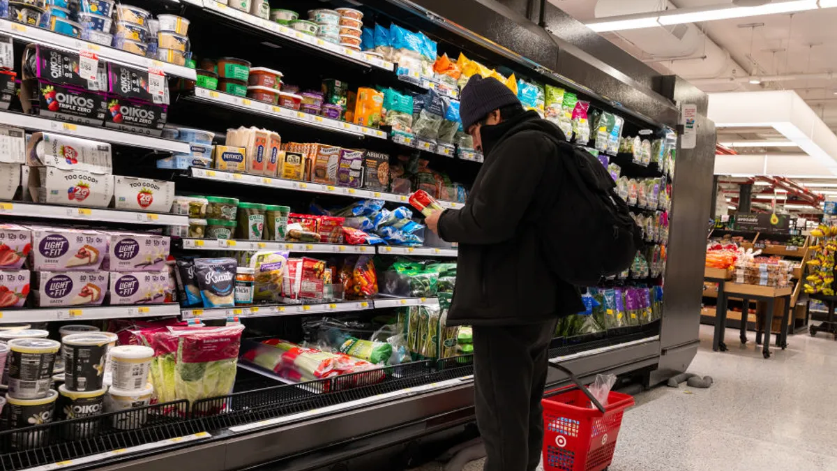 A person is seen shopping at a grocery store.