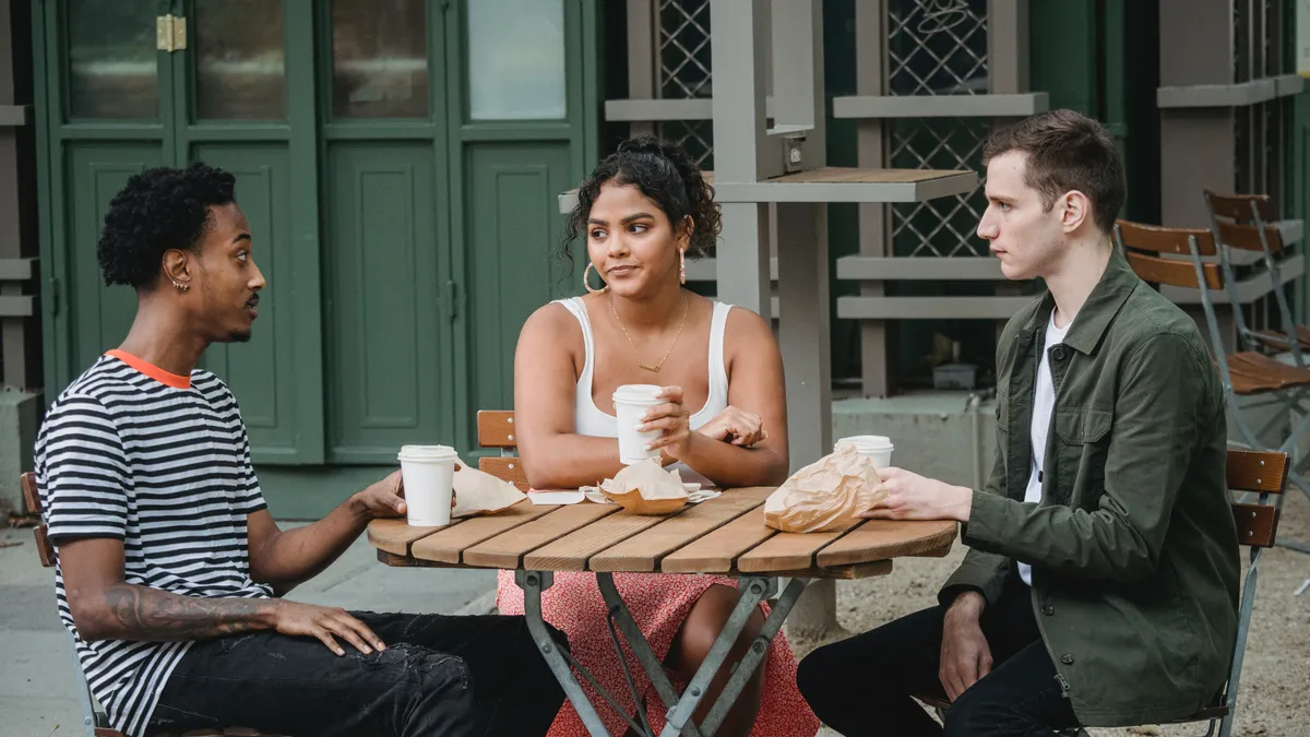 A multiethnic group of colleagues drink coffee