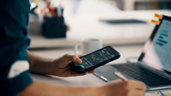 Adult man checking financial information on a smart phone