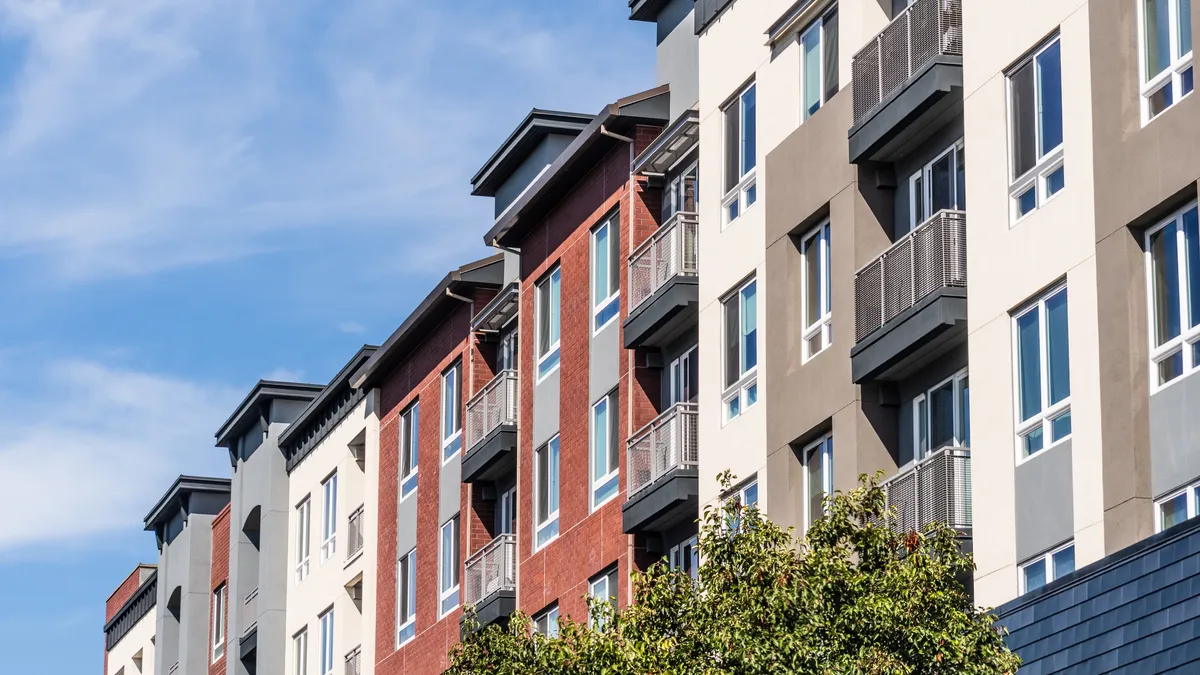 An apartment building dotted with windows and balconies.