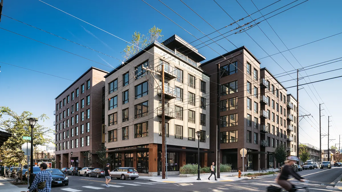 A mid-rise apartment building on a street corner.