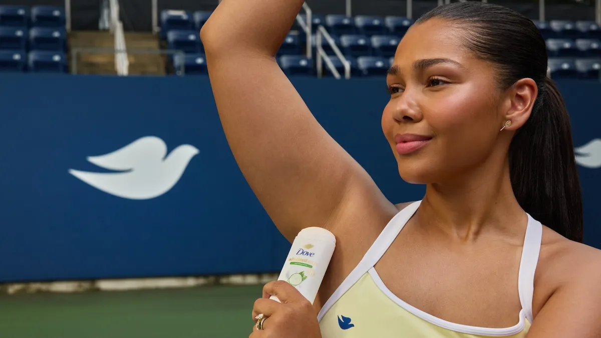 Woman applies Dove deodorant