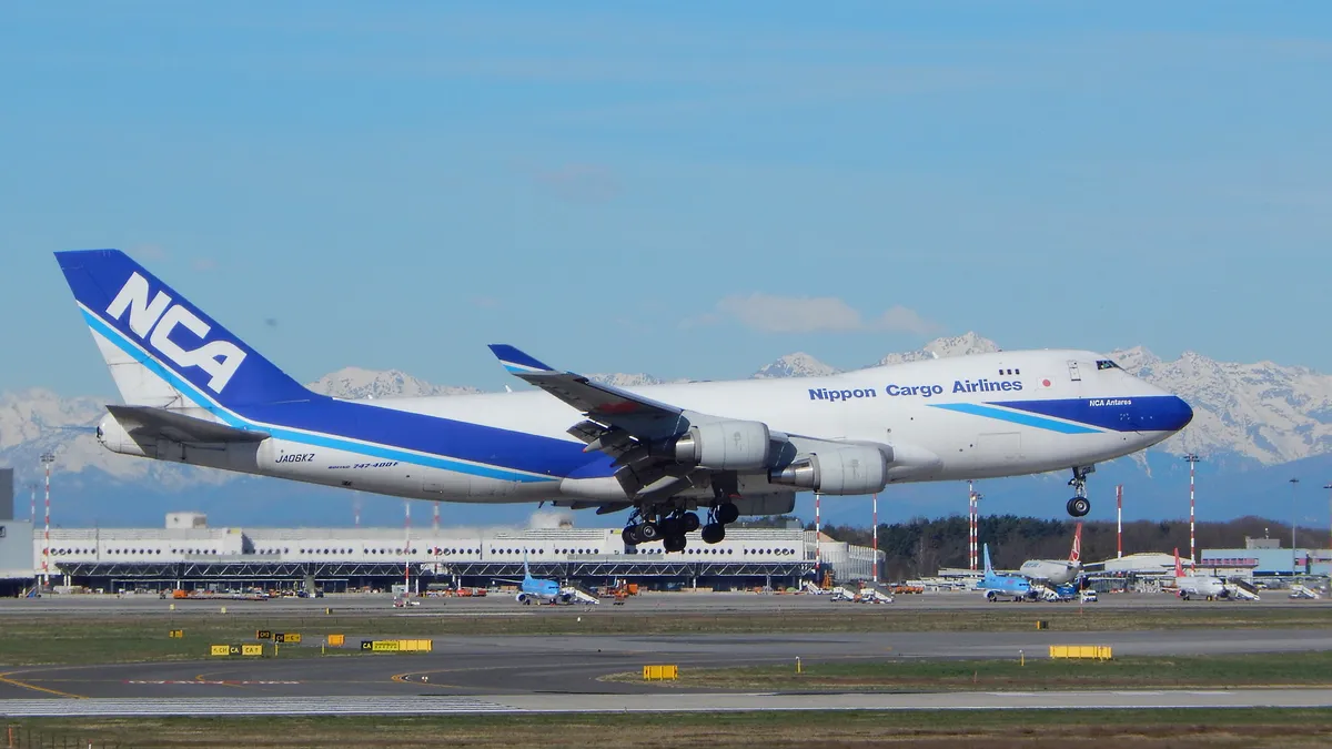 A Boeing 747-400F from Nippon Cargo Airlines takes flight. NYK announced it is transferring its air cargo business to ANA.