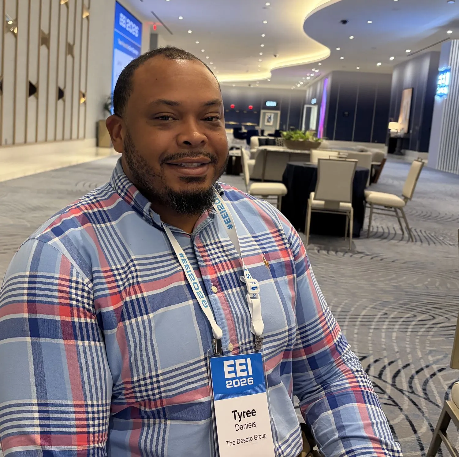 A person in a blue and red checked shirt