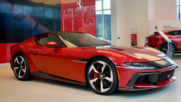 Two red Ferrari vehicles on display in Ferrari dealer showroom in Dublin, Ohio.