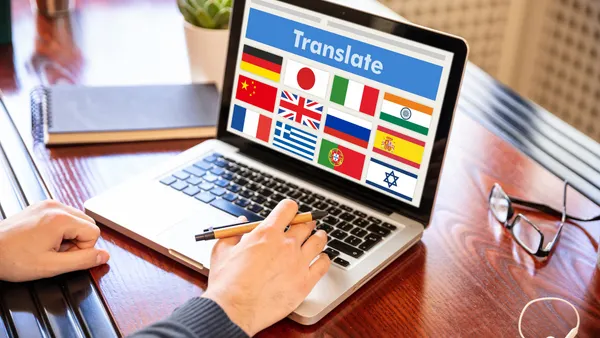 A laptop screen shows flags from multiple countries.