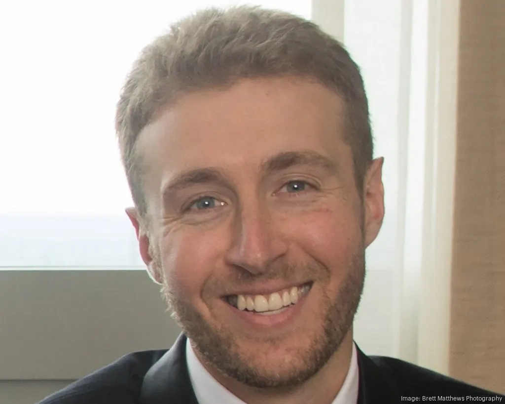 A professional headshot of Andrew Roth.