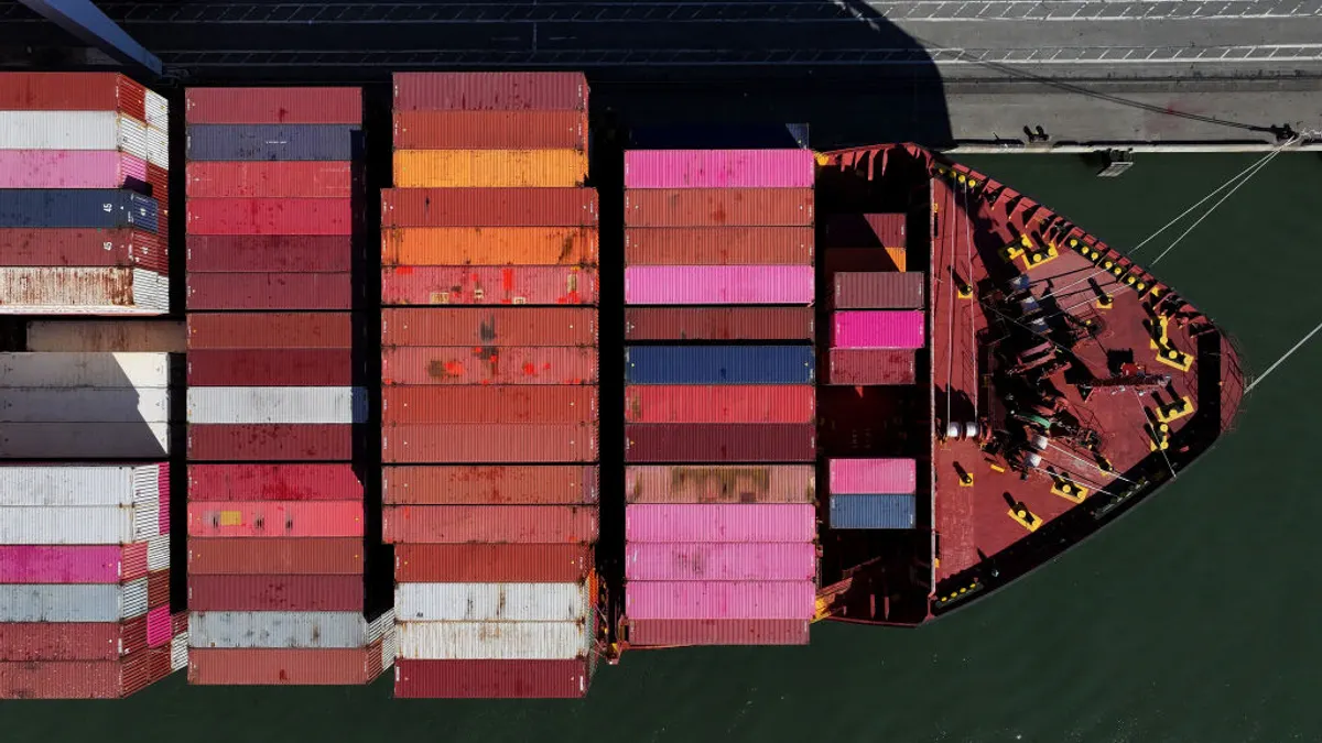 In an aerial view, a container ship sits docked at the Port of Oakland on December 09, 2024 in Oakland, California