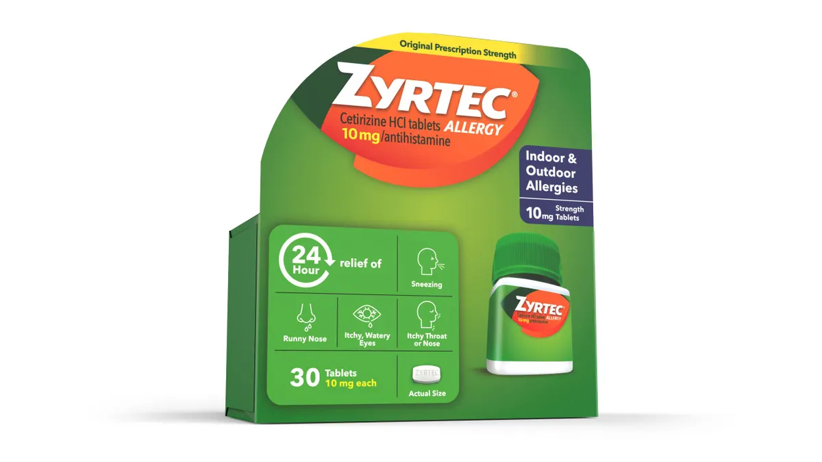 A green box of Zyrtec allergy medication with orange messaging.