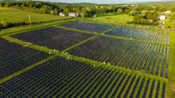 Solar panels in a green field.