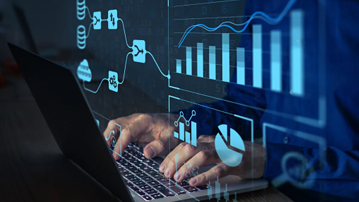 Analyst working with Business Analytics and Data Management System on computer to make report with KPI and metrics connected to database.