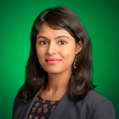 A headshot of Reddit executive Jyoti Vaidee against a green background