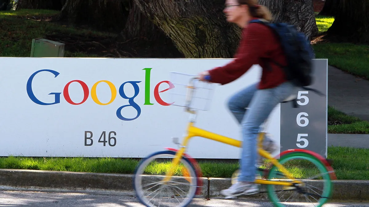 A bicyclist rides by a sign at the Google headquarters March 10, 2010 in Mountain View, California.