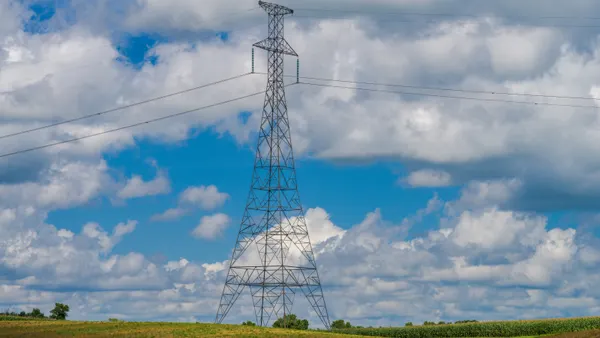 Electric transmission lines run above a field.
