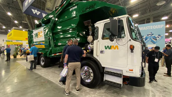 A trash truck on display at a convention