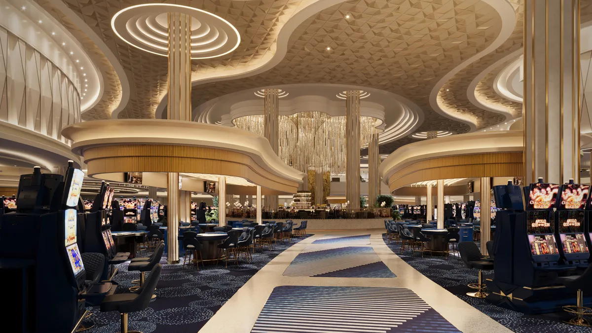 Casino games frame a carpeted walkway under a gold-colored ceiling.