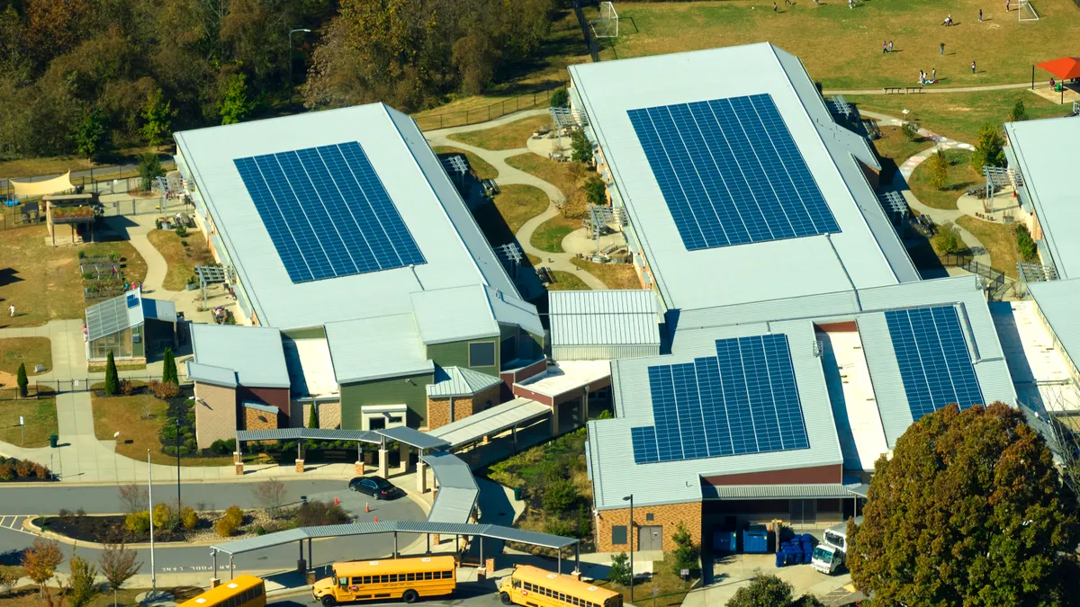 Roof of american school building covered with photovoltaic solar panels