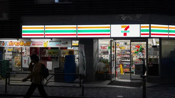 A photo of the exterior of a store in Japan. A sign above the storesays 7-Eleven.
