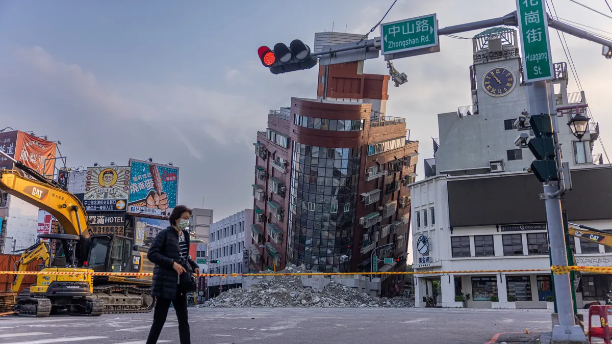 A person walks past an area of a damaged building is cordoned off following the earthquake on April 04, 2024 in Hualien, Taiwan.