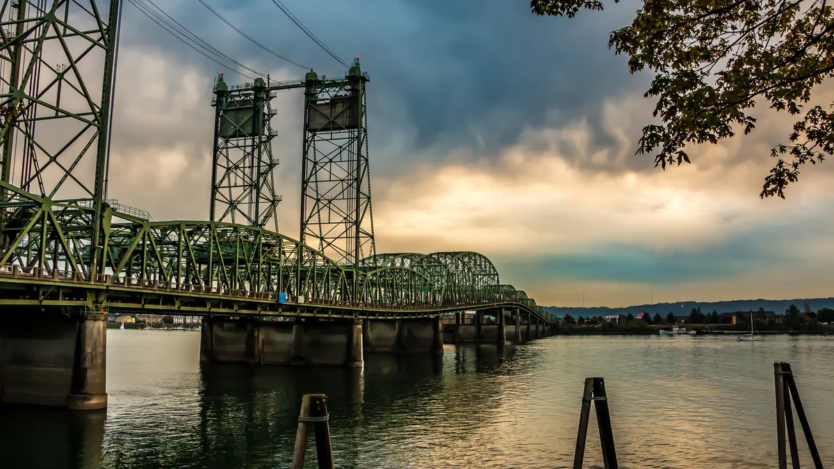 Sun sets in the clouds over the Interstate Bridge across the Columbia River, which connects Portland, Oregon, and Vancouver, Washington.