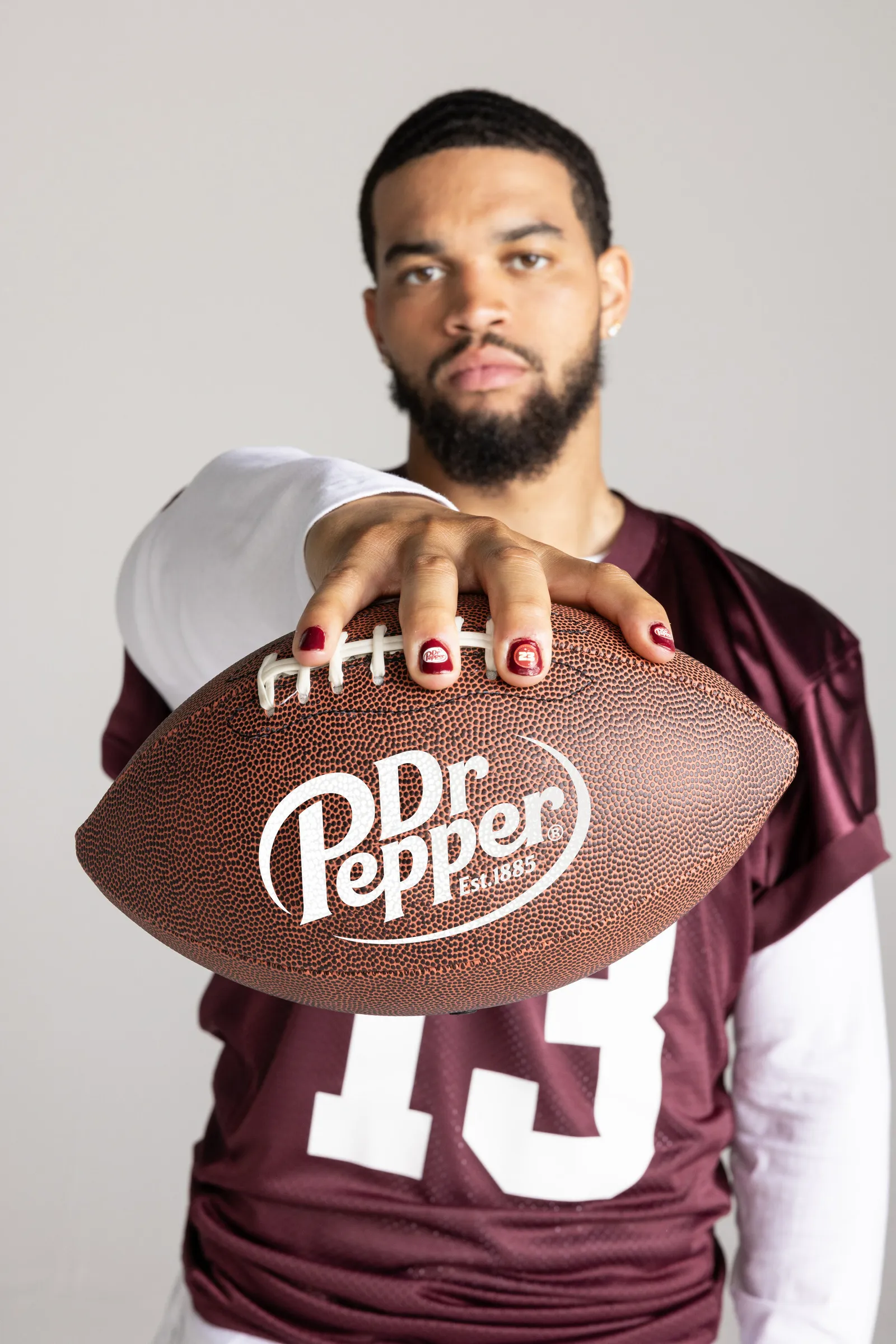 Caleb Williams holds football in manicured hand for Dr Pepper