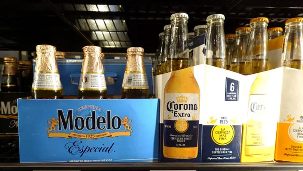 A store shelf houses Modelo and Corona six packs.