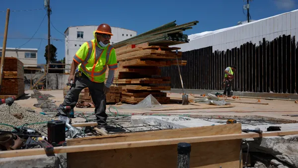 Construction workers begin to rebuild a business
