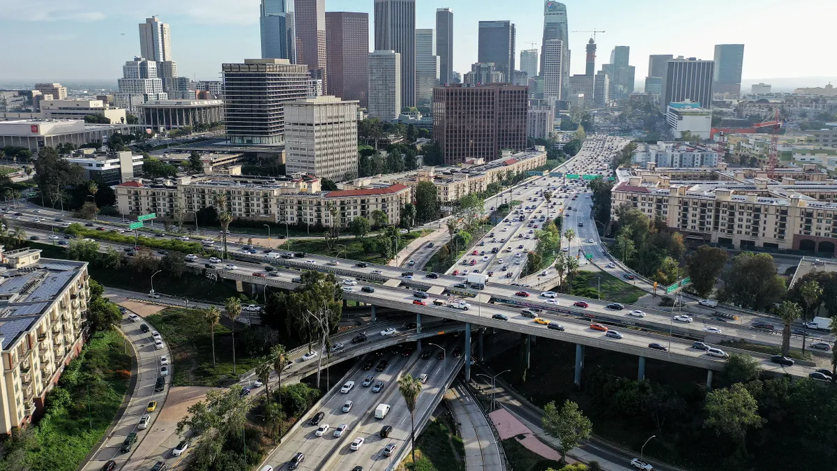 Aerial shot of highways crossing and downtown skyline