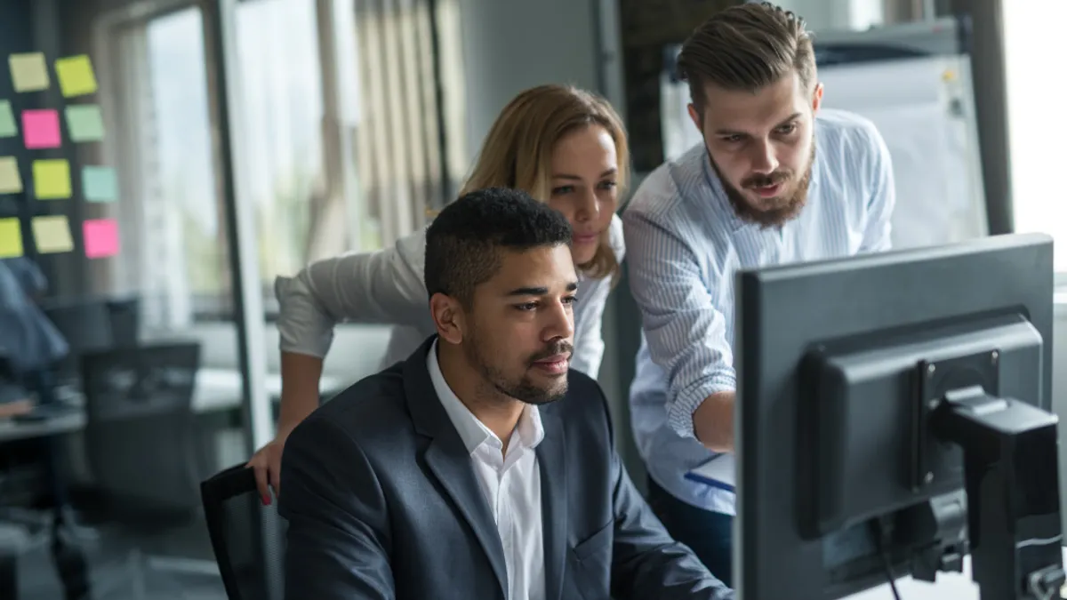Business colleagues working together on a computer in an office.
