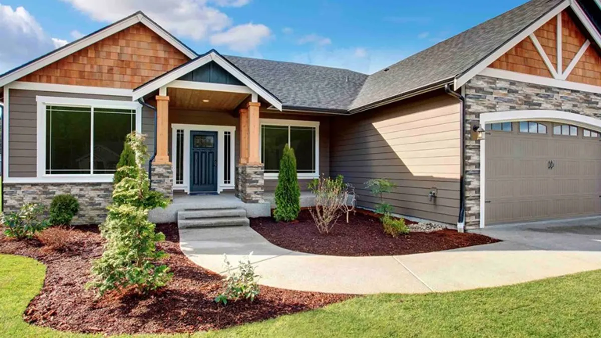 A single-family home with stone and brick-look siding.