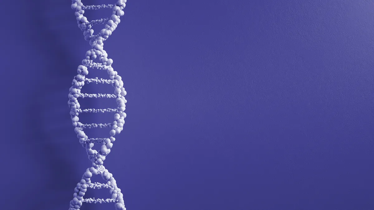 A piece of DNA stretches vertically along a plain background.