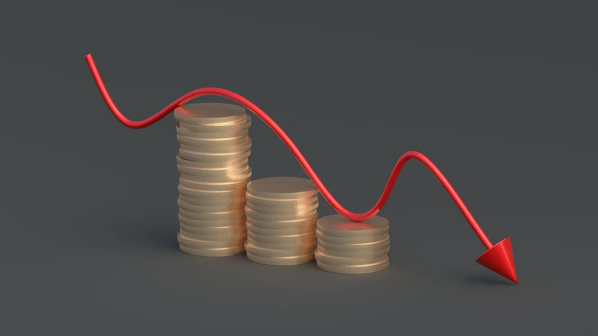 Red down arrow on coins. Internal audit functions lose budget bucks and headcount